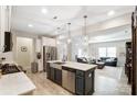 Bright, open-concept kitchen with stainless steel appliances, a large island, and seamless flow into the living area at 1133 Streamside Ln, York, SC 29745