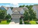 Beautiful home with a well-maintained lawn, mature trees, and a two-car garage in a desirable neighborhood at 2246 Bluebell Way, Tega Cay, SC 29708