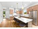 Spacious kitchen featuring a large island, modern cabinets, stainless steel appliances, and pendant lighting at 2413 Pruitt St, Charlotte, NC 28208