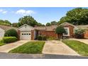 Well-maintained exterior featuring a one-car garage, brick accents, and lush landscaping, offering great curb appeal at 2419 Quail Lake Dr, Charlotte, NC 28210
