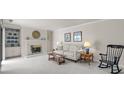 Cozy living room with a fireplace, plush carpeting, built-in shelving, and neutral decor for a comfortable atmosphere at 2419 Quail Lake Dr, Charlotte, NC 28210