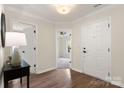 Bright foyer with hardwood floors, white trim, and a view of a bedroom at 2448 Sweet Birch Ct, Gastonia, NC 28054