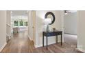 Open hallway featuring hardwood floors, a table, and views into other rooms at 2448 Sweet Birch Ct, Gastonia, NC 28054