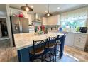 Bright, modern kitchen with a marble island, pendant lighting, stainless steel appliances, and a charming breakfast bar at 2449 Leonhardt Rd, Cherryville, NC 28021