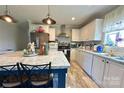 Well-lit kitchen featuring white cabinets, modern appliances, ample counter space, and stylish blue-based center island at 2449 Leonhardt Rd, Cherryville, NC 28021