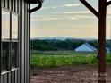 Lovely view of green pastures and distant mountains from the side of this new construction home at 3000 Paul Payne Store Rd, Taylorsville, NC 28681