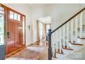 Bright entryway featuring a wooden front door, staircase, and elegant decor at 3237 Sunset Dr, Charlotte, NC 28209