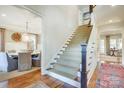Elegant staircase with carpeted steps and dark wood accents leading to the upper level at 3237 Sunset Dr, Charlotte, NC 28209