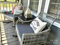 Inviting porch with cozy seating, decorative pillows, and a charming birdhouse at 3810 Biggers Rd, York, SC 29745