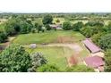 Expansive aerial view of property featuring a residence and lush surrounding landscape with mature trees at 4026 Biggerstaff Rd, Maiden, NC 28650