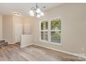 Bright dining area with natural light from large windows, featuring hardwood floors and neutral wall color at 5322 Jocelyn Ln, Charlotte, NC 28269