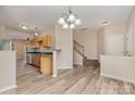 Open-concept living space showcasing hardwood floors, neutral paint and a staircase leading to the upper level at 5322 Jocelyn Ln, Charlotte, NC 28269