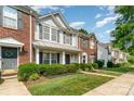 A pleasant street featuring well-maintained townhomes with manicured lawns and sidewalks under a sunny sky at 5322 Jocelyn Ln, Charlotte, NC 28269