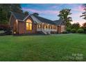 Charming brick home with a welcoming front porch and well-maintained landscaping at 5916 Cashion Rd, Huntersville, NC 28078