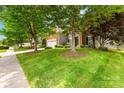 Beautiful home exterior with lush landscaping, mature trees, and well-maintained lawn along a sidewalk at 622 Lorain Nw Ave, Concord, NC 28027
