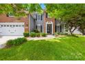 Welcoming two-story home with a brick and siding exterior, featuring a manicured lawn and a two-car garage at 622 Lorain Nw Ave, Concord, NC 28027
