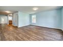 Open-concept living room featuring wood floors, natural light, and a seamless flow into the kitchen area at 672 Carybrook Ct, York, SC 29745