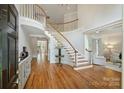 Grand foyer with a curved staircase, hardwood floors, and elegant trim at 7319 Stonehaven Dr, Waxhaw, NC 28173