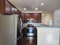 Well-equipped kitchen with stainless steel appliances, granite countertops, and stylish backsplash at 7323 Jane Parks Way, Charlotte, NC 28217