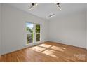Bright bedroom with natural light, hardwood floors and track lighting at 765 Portpatrick Pl, Fort Mill, SC 29708