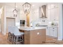 Bright kitchen features an island, pendant lighting, stainless appliances, and ample cabinet space at 1059 Sage Pine Cir, Clover, SC 29710