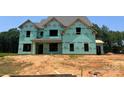 New construction showing wrapped walls, window framing, and the early stages of this custom home at 11009 Tyler Brook Ln # Oak0043, Mint Hill, NC 28227