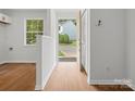 Bright foyer with wood-look flooring, white walls, window and view of the neighborhood at 1231 Maple Shade Ln, Charlotte, NC 28270