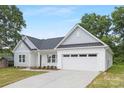 Charming single-Gathering home with a two-car garage, manicured front lawn, and lovely landscaping at 1312 W Monroe Rd, Salisbury, NC 28144