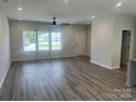 Spacious living room with large windows, ceiling fan, hardwood floors, and neutral paint at 1312 W Monroe Rd, Salisbury, NC 28144