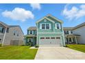 Beautiful two-story home with a well-maintained lawn, two-car garage, and a cozy front porch under blue skies at 133 Aspire Cir, Wingate, NC 28174