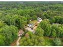 Aerial view showcasing the property's placement in a verdant, wooded area, close to other homes at 136 Digh Cir # 4, Mooresville, NC 28117