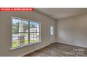 Bright entryway featuring wood-look floors and a large window overlooking the front yard at 1369 Secrest Commons Dr, Monroe, NC 28112