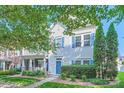 Inviting two-story house with blue shutters and lush green landscaping at 13820 Cypress Woods Dr, Huntersville, NC 28078