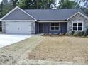 Attractive single-story home with a two-car garage, stone accents, and manicured front yard at 1802 Cooper Ave, Kannapolis, NC 28081