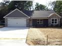 Attractive single-story home showing gray exterior, stone accents, and a two-car garage at 1802 Cooper Ave, Kannapolis, NC 28081