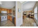 View of the kitchen and dining area with wood cabinets and stainless steel appliances at 21214 W Tern Ct, Fort Mill, SC 29707