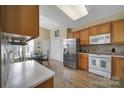 Bright kitchen with stainless steel refrigerator, wood cabinets, and breakfast nook with table and chairs at 21214 W Tern Ct, Fort Mill, SC 29707