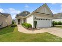 Charming single-story home featuring a two-car garage, well-maintained lawn, and inviting front entrance at 23117 Whimbrel Cir, Fort Mill, SC 29707