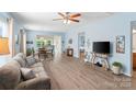 Spacious living room featuring hardwood floors, plenty of natural light, and an open concept design at 23117 Whimbrel Cir, Fort Mill, SC 29707