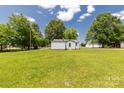 View of expansive green backyard with mature shade trees at 2742 Flat Creek Rd, Lancaster, SC 29720