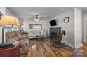 Cozy living room featuring hardwood floors, a fireplace, and comfortable seating area at 309 Ackert Ave, Salisbury, NC 28144