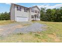 Two-story home with an attached garage and vinyl siding on a gravel lot with a green lawn at 3401 Shillinglaw Rd, Sharon, SC 29742