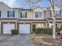 Charming townhouse with a one car garage, brick accents, and a well maintained lawn at 463 Delta Dr, Fort Mill, SC 29715