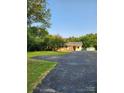 Quaint home with mature trees, a spacious driveway and a charming exterior at 490 S Moose Rd, Mount Pleasant, NC 28124