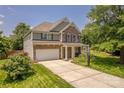 Charming two-story home featuring stone and siding, a two-car garage, and manicured landscaping at 516 Fair Oaks Dr, Fort Mill, SC 29708