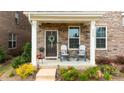 Inviting covered front porch with rocking chairs and decorative wreath for relaxed outdoor living at 5440 Kinsbridge Dr, Charlotte, NC 28227