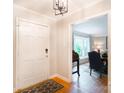 Inviting foyer with hardwood floors, light gray walls, and a glimpse into the dining room at 6128 Coatbridge Ln, Charlotte, NC 28212