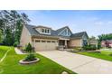 Lovely home featuring a long driveway, attached garage, and beautiful landscaping at 708 Ardent Trl, Belmont, NC 28012