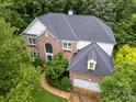 Beautiful brick home with mature trees, a two-car garage, and well-maintained roof at 8219 Beardsley Dr, Charlotte, NC 28269