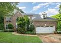 Charming brick home with a two-car garage, manicured lawn, and tasteful landscaping at 8219 Beardsley Dr, Charlotte, NC 28269